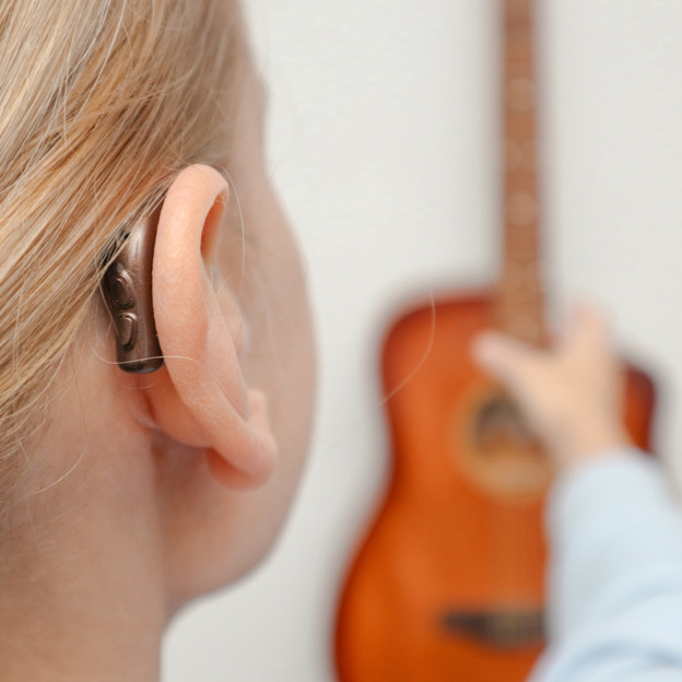 A,Woman,With,Hearing,Loss,Can,Hear,And,Play,Guitar